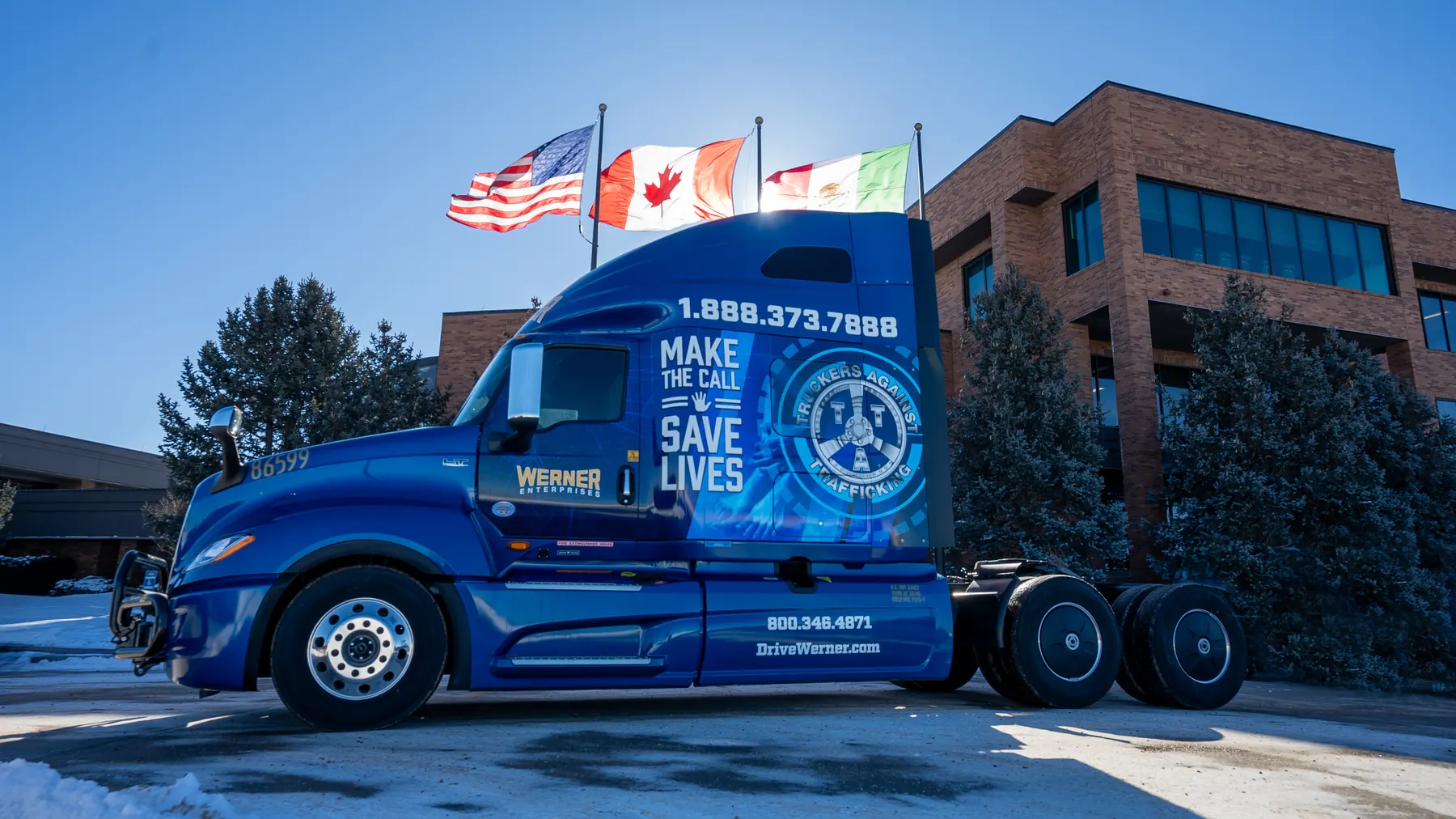 Werner truck wrapped with the Truckers Against Trafficking “Make the Call, Save Lives” message in front of the Omaha headquarters