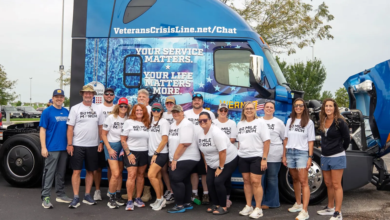 Werner 50 Mile March team posing in front of the Veterans Crisis Line truck wrap.