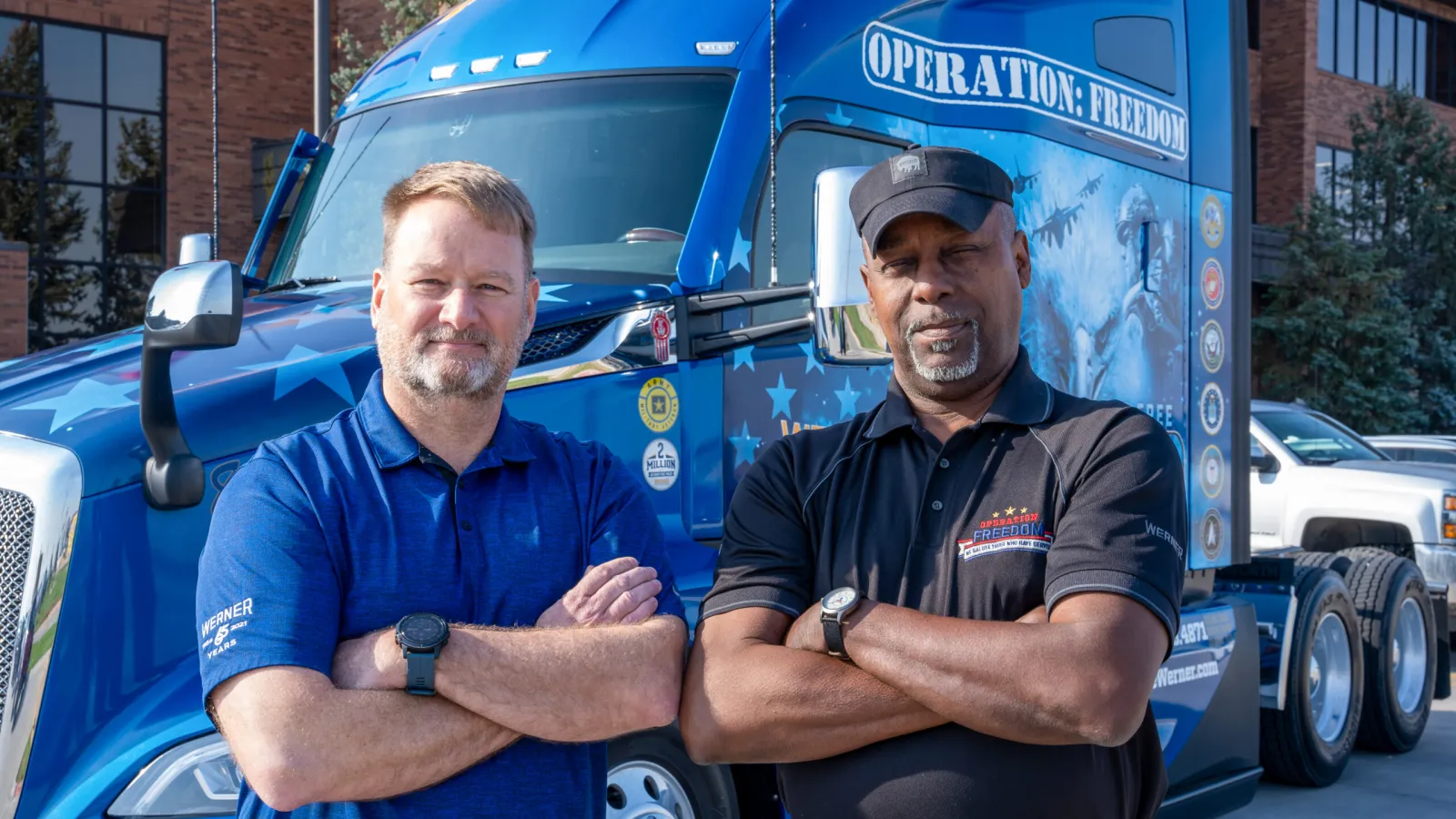 Two Werner military recruiting team members standing in front of the Operation Freedom truck.