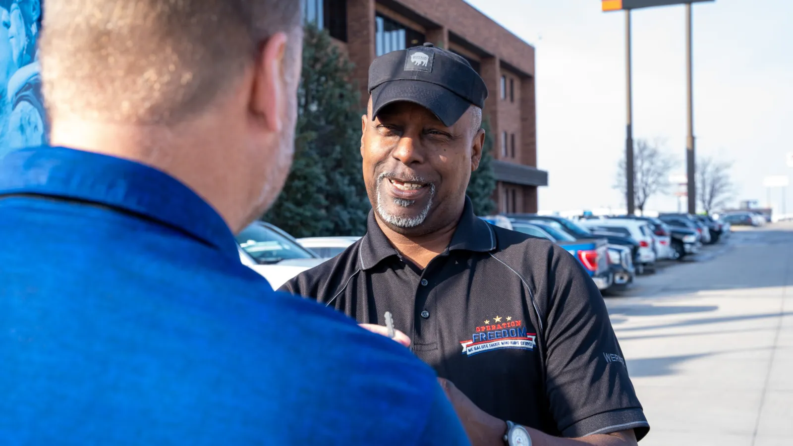Werner military recruiter in an Operation Freedom polo talking with a candidate outside the Omaha headquarters.