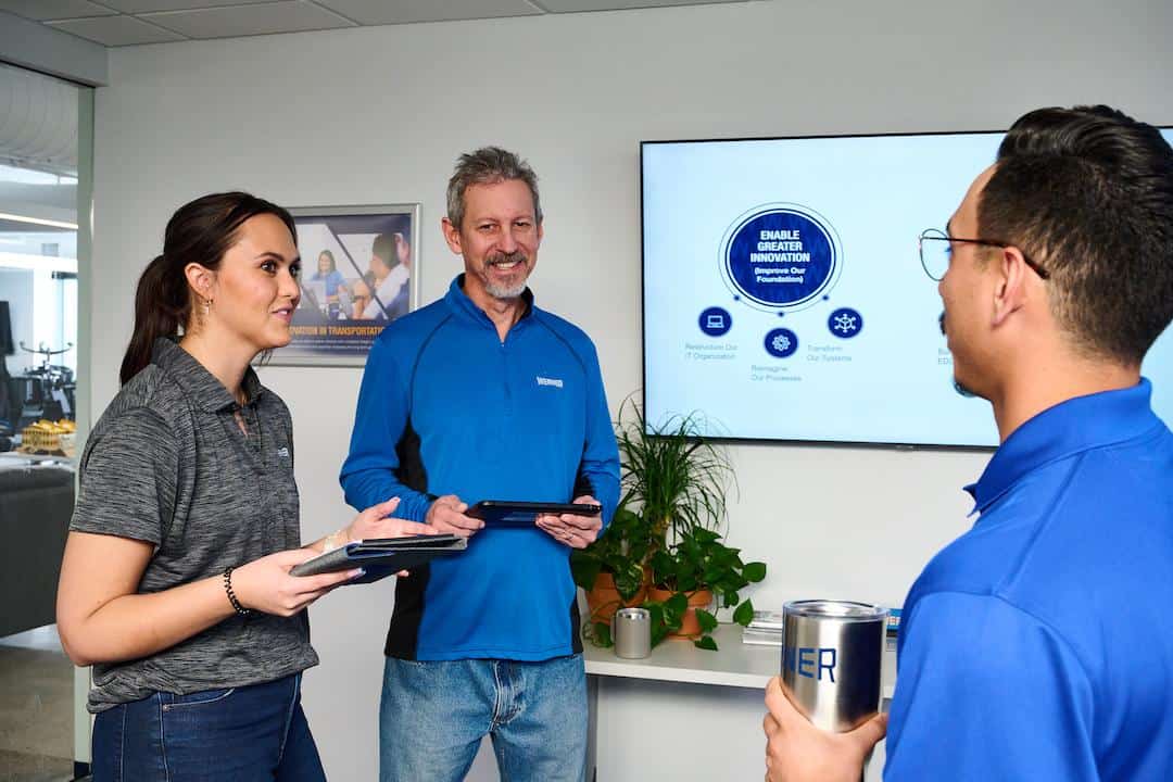 Werner associates reviewing technology on tablets