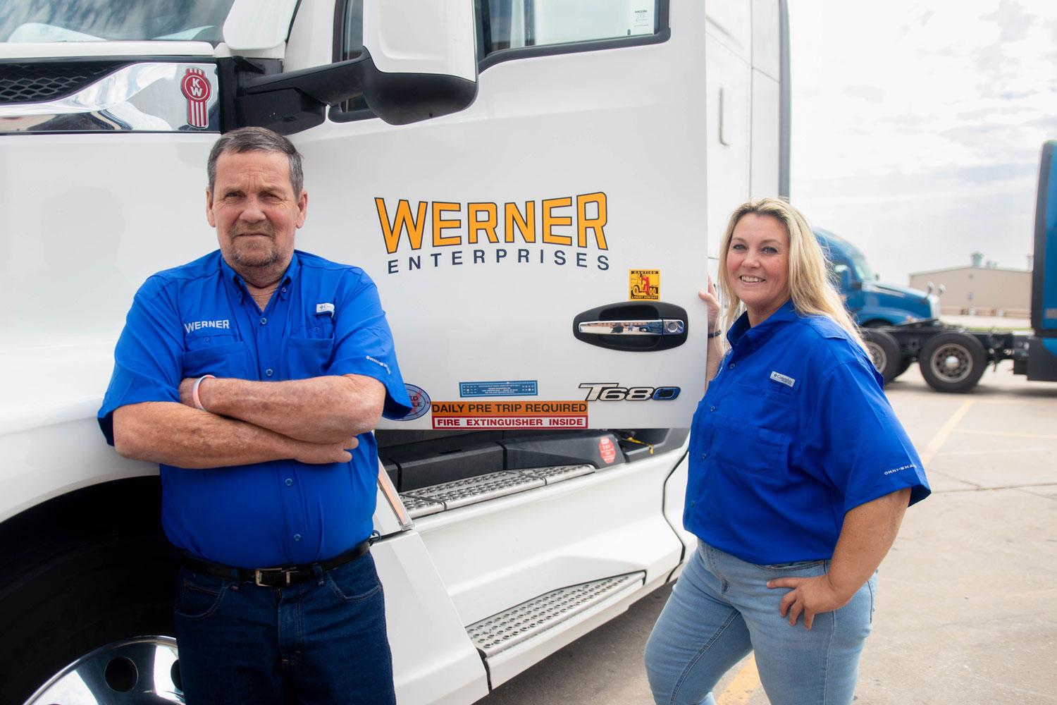 Bobby and Christine, a Werner team driving pair, beside their truck